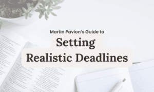 Setting Realistic Deadlines guide: Open book and notebook on a white desk.
