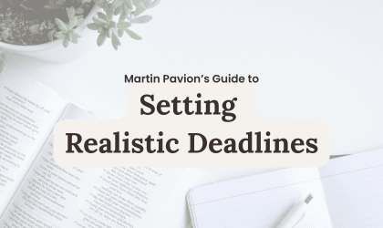 Setting Realistic Deadlines guide: Open book and notebook on a white desk.